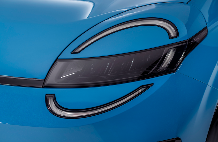Close-up of a blue car's headlight and front design.