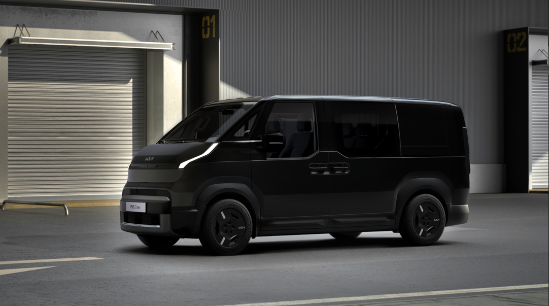 Black van parked indoors with alloy wheels and a modern design.