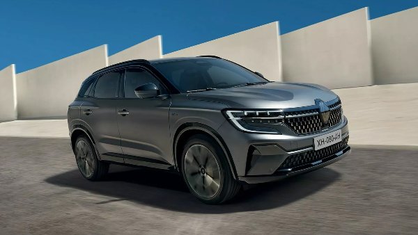 A grey SUV driving on a tarmac road.
