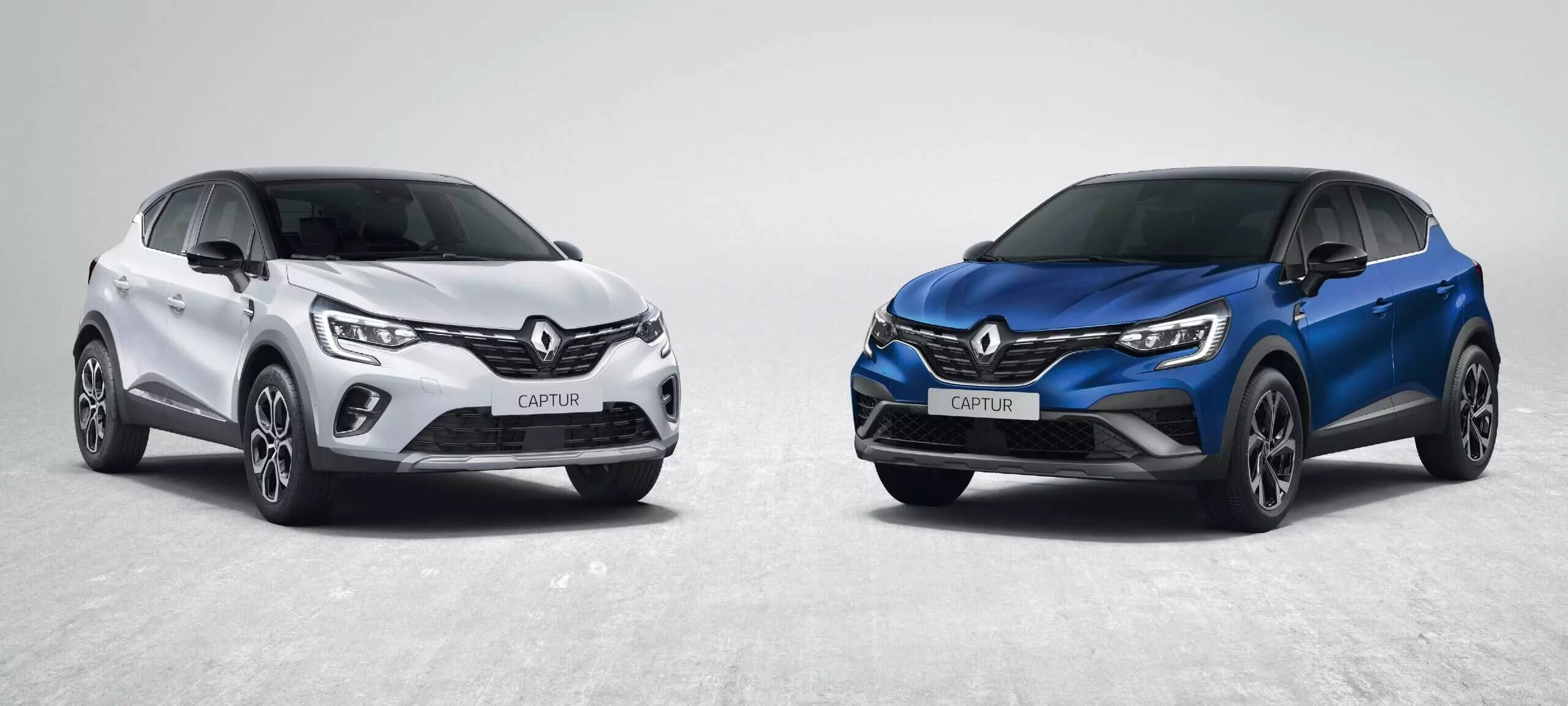 Two Renault Captur cars, one silver and one blue.