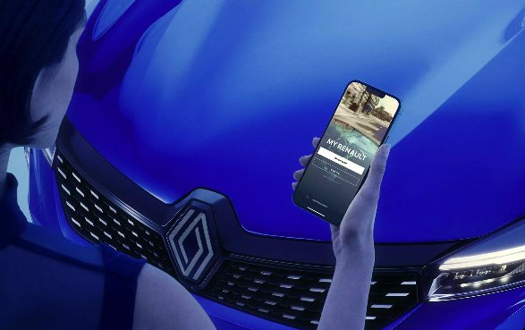 Person using smartphone app by a blue car grille.