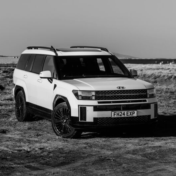 A white Hyundai 4x4 vehicle parked on uneven terrain.
