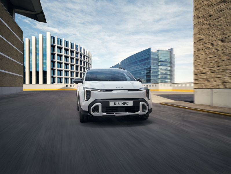 White car driving in a modern city environment.