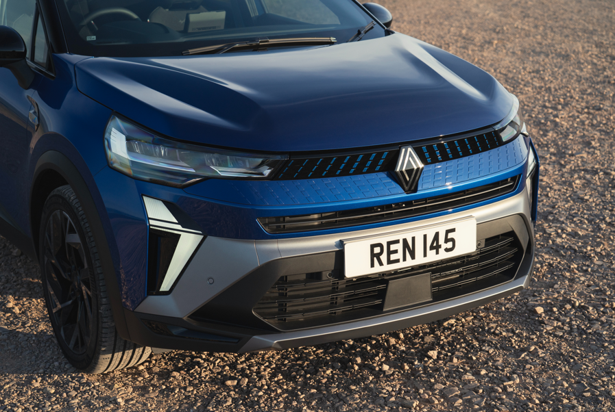 Close-up of the front of a blue car with a visible number plate reading REN 145.